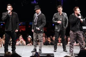 In this picture provided by Starpix, from left, Jeff Timmons, Justin Jeffre, Nick Lachey, and Drew Lachey of 98 Degrees perform during the announcement of The Package Tour, Tuesday, Jan. 22, 2013 in New York. The major summer tour will feature New Kids on the Block, 98 Degrees and Boyz...