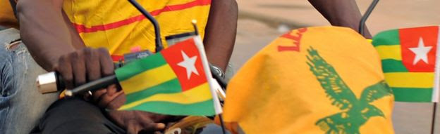 A motorbike flying Togolese flags