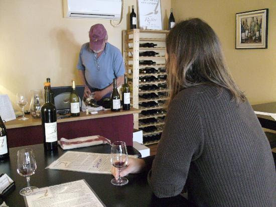 the man enjoying a glass of vino. By audballg. austin, texas