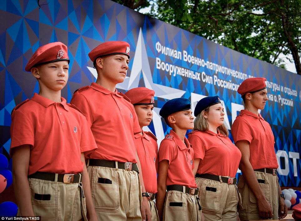Members of the Young Army, Yunarmiya, looked stern as they stood on a stage in bright red berets as their proud parents watched on