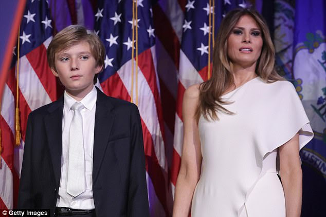A new book says that Melania Trump (right) was visibly crying, and not of joy, on election night upon hearing that her husband had won the race. She stood next to son Barron Trump (left) as her husband gave his early morning acceptance speech 