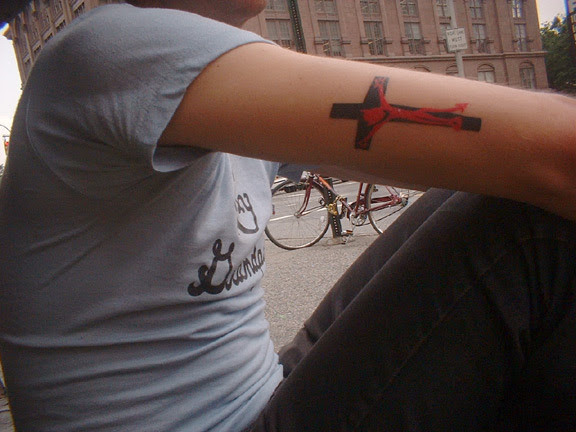 The cross tattoos are of a crucified Satan.