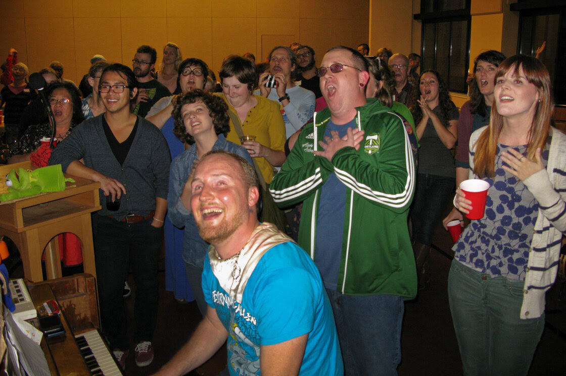 Todd Fadel, at piano, leads singers at a recent gathering of Beer & Hymns at First Christian Church Portland.