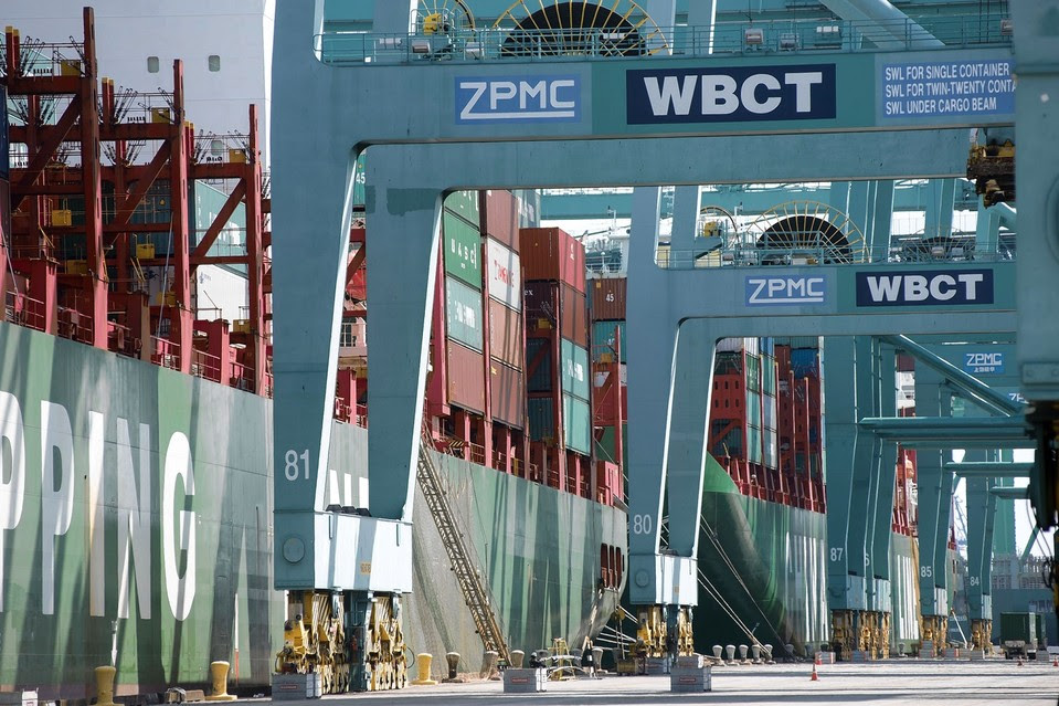A container ship waited to be unloaded at a terminal in the Port of Los Angeles last week. It could be as long as six months before shipping returns to normal after a labor dispute.