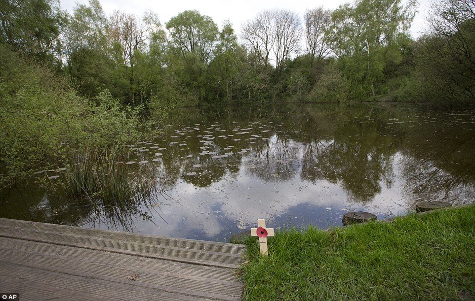 A wooden cross with a poppy is left at a bomb crater named the 'Pool of Peace' in Heuvelland, Belgium. The crater was created by the largest of 19 mine explosions detonated to signal the start of the Messines phase of the Third Battle of Ypres. The explosion was set off on June 7, 1917 underneath one of the then highest German front-line positions on Messines Ridge. The blasts were reportedly heard as far away as London
