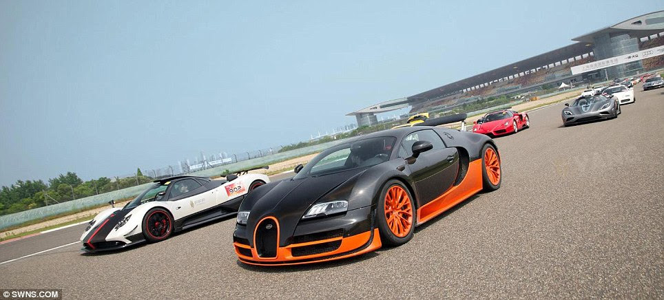 Money spinners: A £4million Bugatti Veyron Super Sport and a £2million Pagani Zonda Cinque lead the dizzying array of supercars around the Shanghai F1 track 