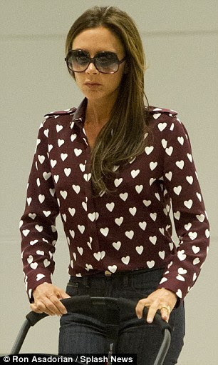 He had it first! Victoria's shirt is strikingly similar to the £350 Burberry shirt Harry wore to the One Direction movie premiere earlier this month