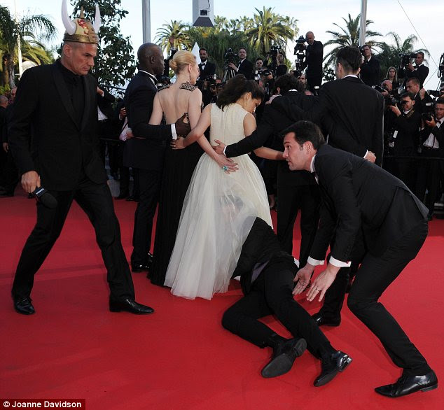 Unwanted guest: Pest Vitalii Sediuk has struck again, crashing the How To Train Your Dragon 2 red carpet Cannes premiere to climb under America Ferrera's dress