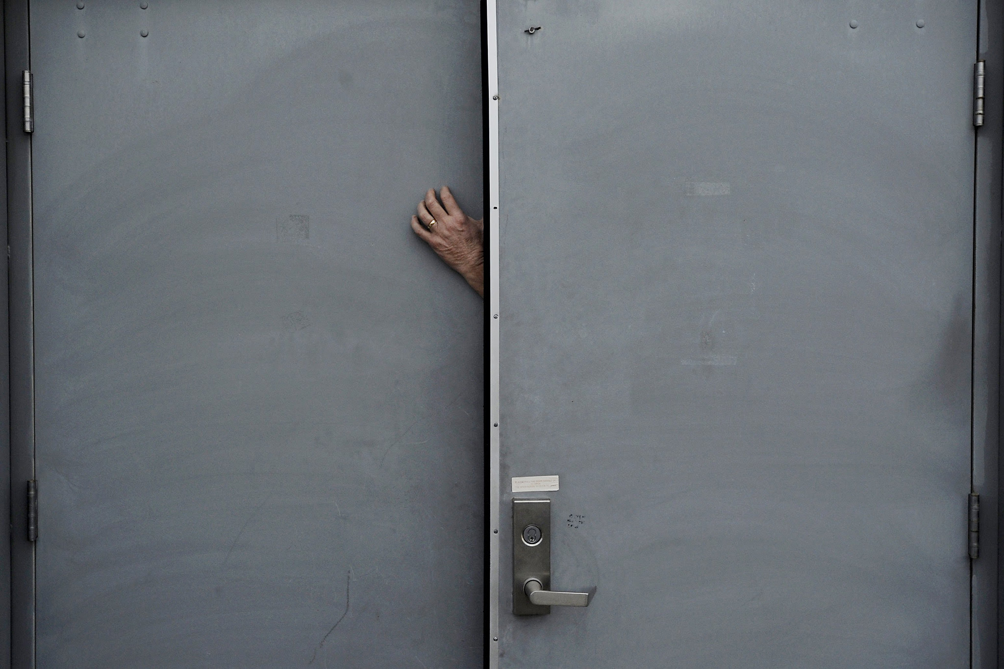 A volunteer for U.S. Democratic presidential candidate Sanders holds the door open ahead of a campaign rally in Fairfield, Iowa...Billy Hunter, a volunteer for U.S. Democratic presidential candidate Bernie Sanders, holds a door open while waiting for Sanders to arrive at a campaign rally in Fairfield, Iowa January 28, 2016. REUTERS/Mark Kauzlarich