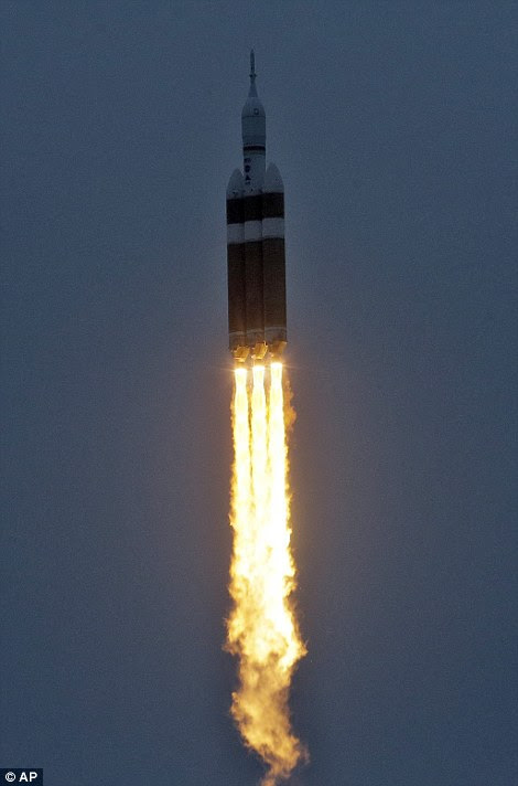 Nasa's new Orion spacecraft streaked into orbit Friday on a high-stakes test flight meant to usher in a new era of human exploration leading ultimately to Mars