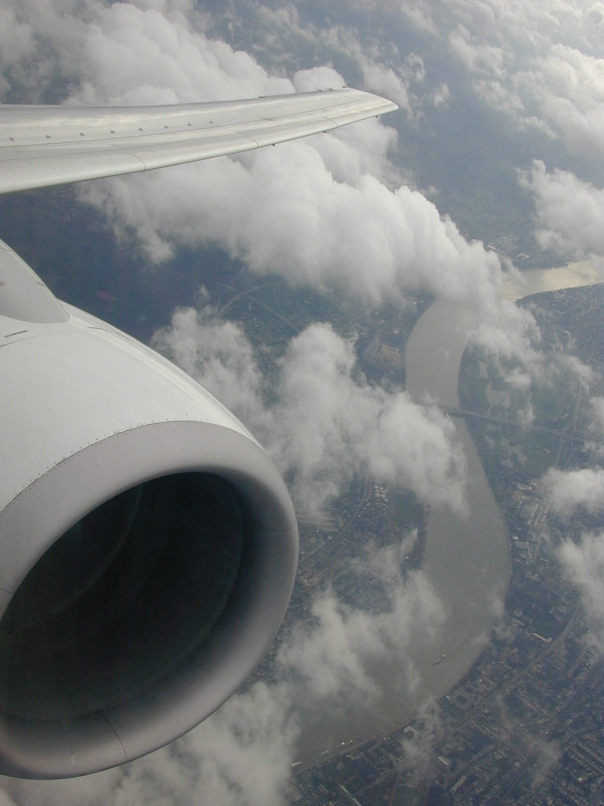 airplane wing airborne engine clouds in flight