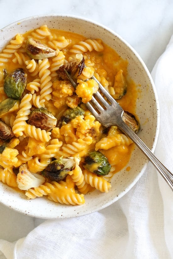 It's October, so Pumpkin Mac and Cheese with Roasted Cauliflower and Brussels Sprouts is a must for the Fall! Using pumpkin puree makes a creamy light cheese sauce, without having to add cream or too much cheese. You can make your own pumpkin puree or use organic canned pumpkin to make it faster!