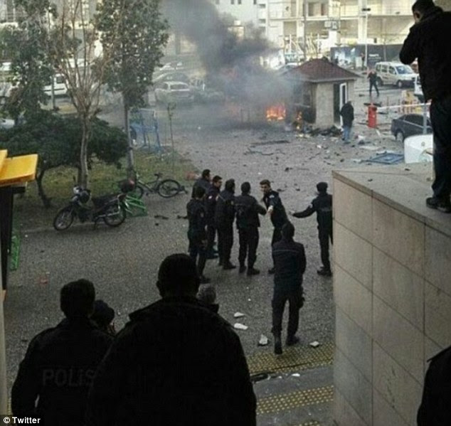 Pictures show flames coming from near a small building as Turkish police descend on the scene