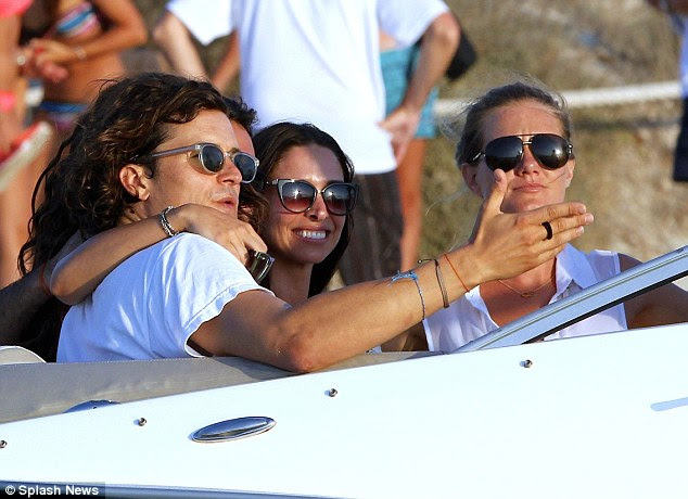 And here is yet another woman: A blonde in a white sleeveless top also joined the group