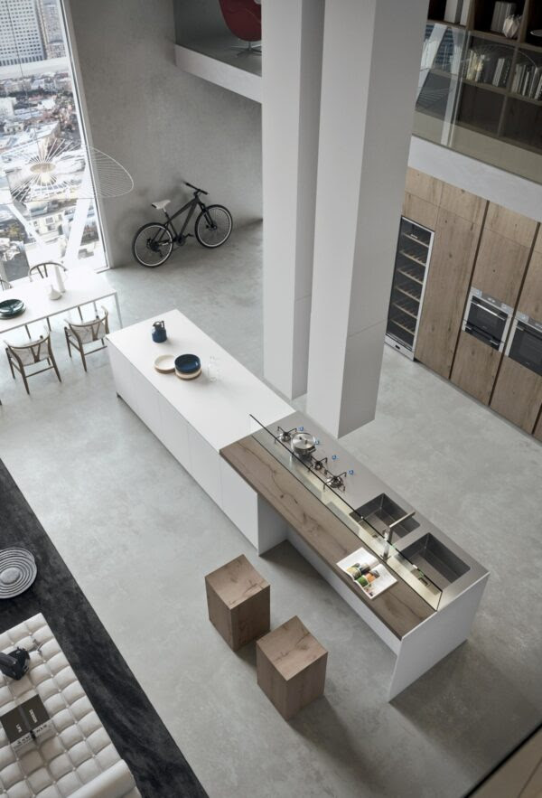 Using natural, unpainted wood and neutral grays and whites, the design gives the impression of minimalism while still including plenty of features and furnishings. The Overhead light fixtures spread out like broken umbrellas and serve to make the space and it's massive ceilings a bit less daunting.