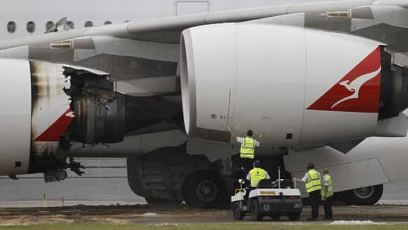 Technicians work on the Qantas Airways A380 passenger plane forced to make an emergency landing at Changi airport in Singapore on Nov. 4.  