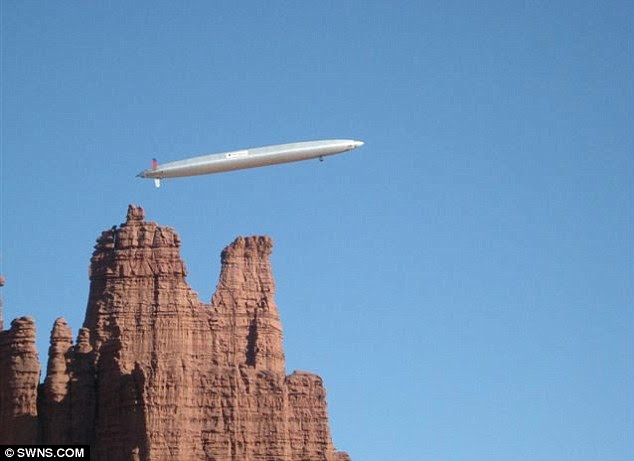 Serving the skies: The 54ft-long HB50 Hyperblimp flies beside a rocky outcrop near Ogden, Utah