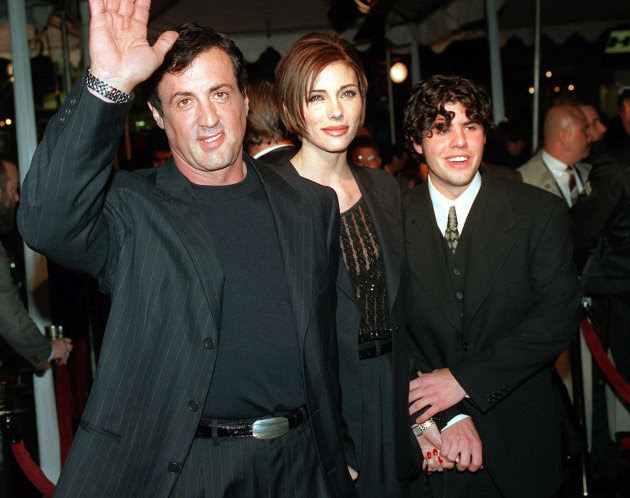 FILE - In this Dec. 5, 1996 file photo, Sylvester Stallone, left, star of the film "Daylight," arrives at the film's world premiere with his girlfriend Jennifer Flavin, center, and his son Sage Stallo