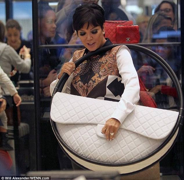 Kim Kardashian's mother Kris Jenner trying on the enormous Chanel hula hoop bag for size in London's Selfridge's