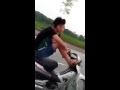 Young men drove motor by foot , just talk on phone her mother breeze