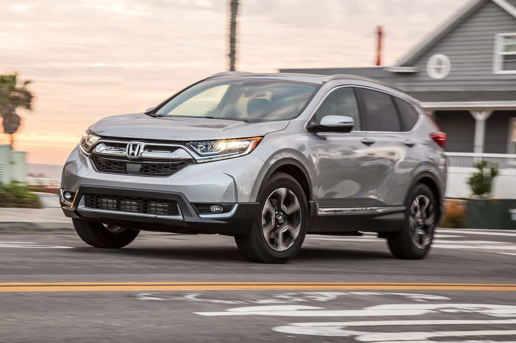 2017 Honda CR V Touring AWD front three quarter in motion 03