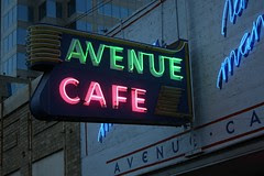 avenue cafe neon sign lit