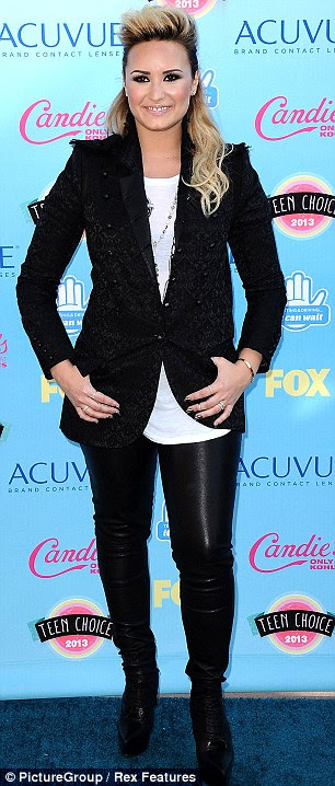 Hell for leather: Demi Lovato sported black trousers, a beaded black blazer and a white T--shirt for the event 