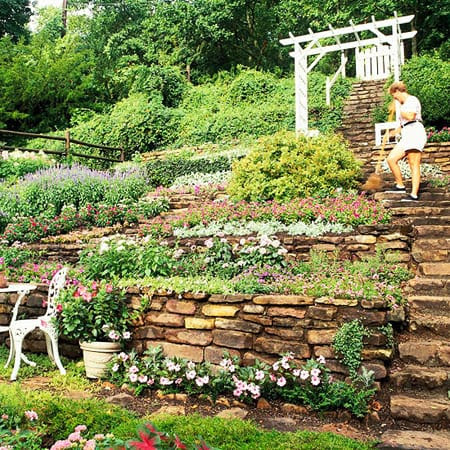 The pool deck extends to the next level of the slope, secured by 