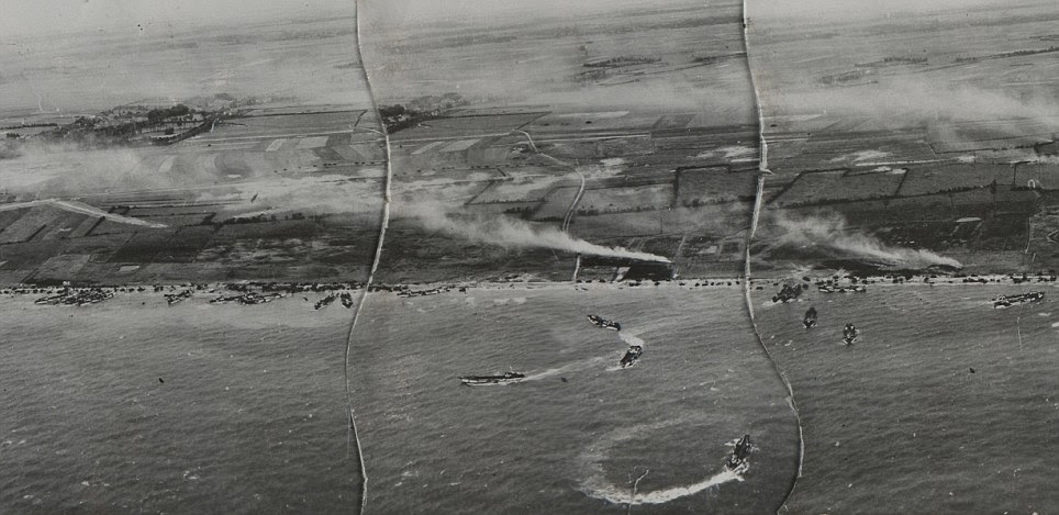 Massive loss of life: Burning French villages and the movement of Allied equipment can be seen in this image of Juno beach, which was invaded by troops from the 3rd Canadian Infantry Division, along with Royal Marine commandos and naval support. Some 359 Allied troops were killed at the beach and a further 574 injured