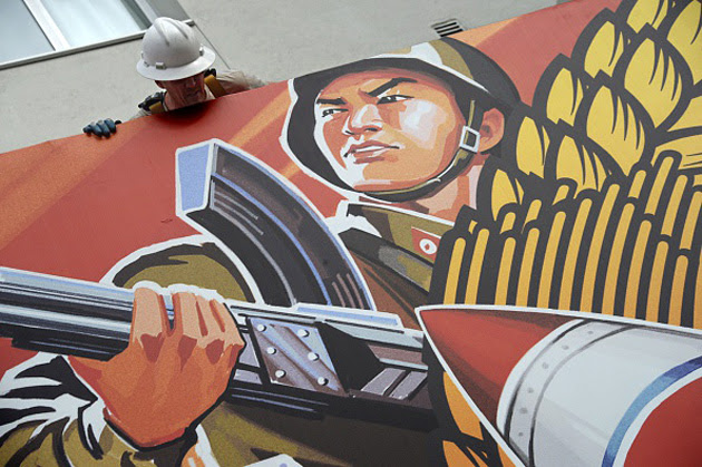 A banner advertising 'The Interview' goes down