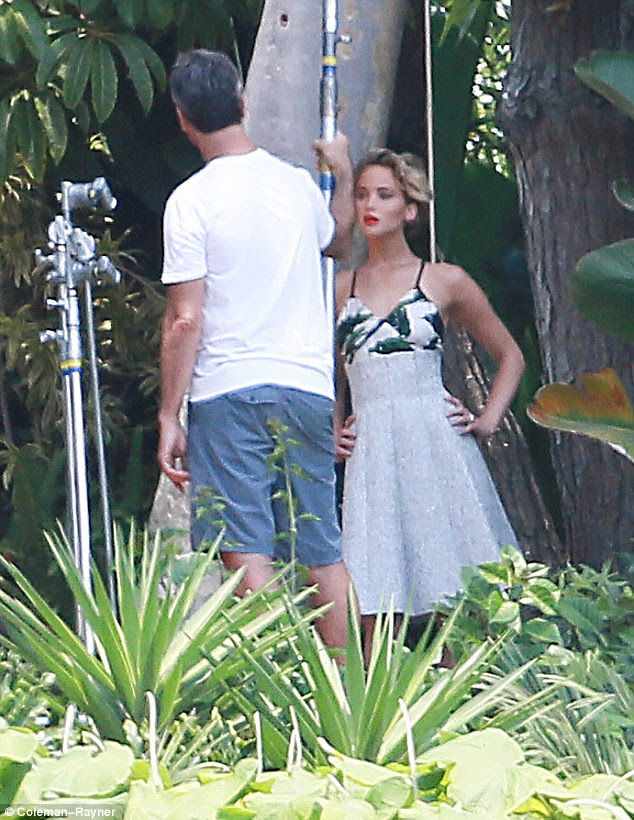 Height of glamour: The 23-year-old was then seen wearing a Fifties-style silver frock that sported a green pattern at the bust