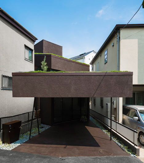overhanging green roof cave house