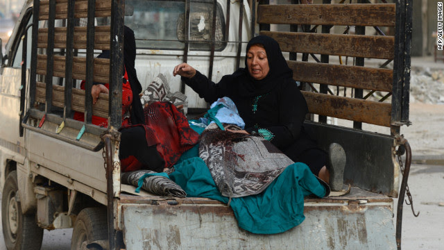 An injured Syrian woman rides to a hospital after an airstrike by regime forces in Aleppo on Tuesday.