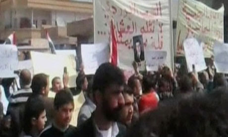 Anti-government demonstrators march in Daraa, Syria