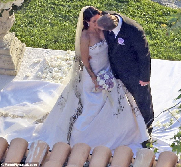 Sealed with a kiss: The former CEO of West Coast Choppers kissed his drag racing wife following the nuptials