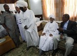 Islamist opposition leader Hassan Turabi, second right receives greeters at his home in Khartoum, Sudan Monday, March 9, 2009.