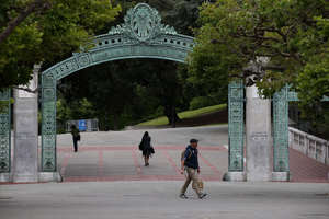 Pedestrians walk by Sather Gate on the UC Berkeley campus on May 22, 2014 in Berkeley, California.