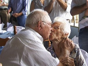 Sebastiana de Oliveira Nates, 82, and Isauro Ferreira Nates, 86, kiss while celebrating 65 years of marriage