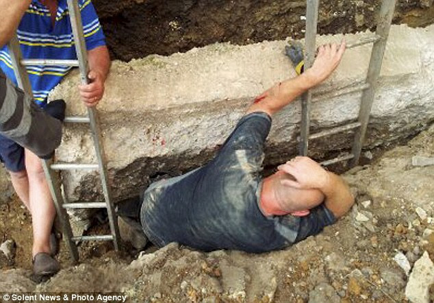 Lucky escape: Paul Colletta's legs and feet were crushed by this block of concrete after it slipped as he dug a trench in his garden