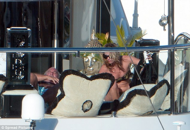Kate Moss displays a Black Bikini around a Yacht in Saint Barthelemy