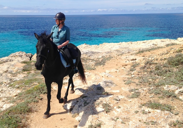 Admiring the view on horse at Son Bou Cami de Cavalls Menorca