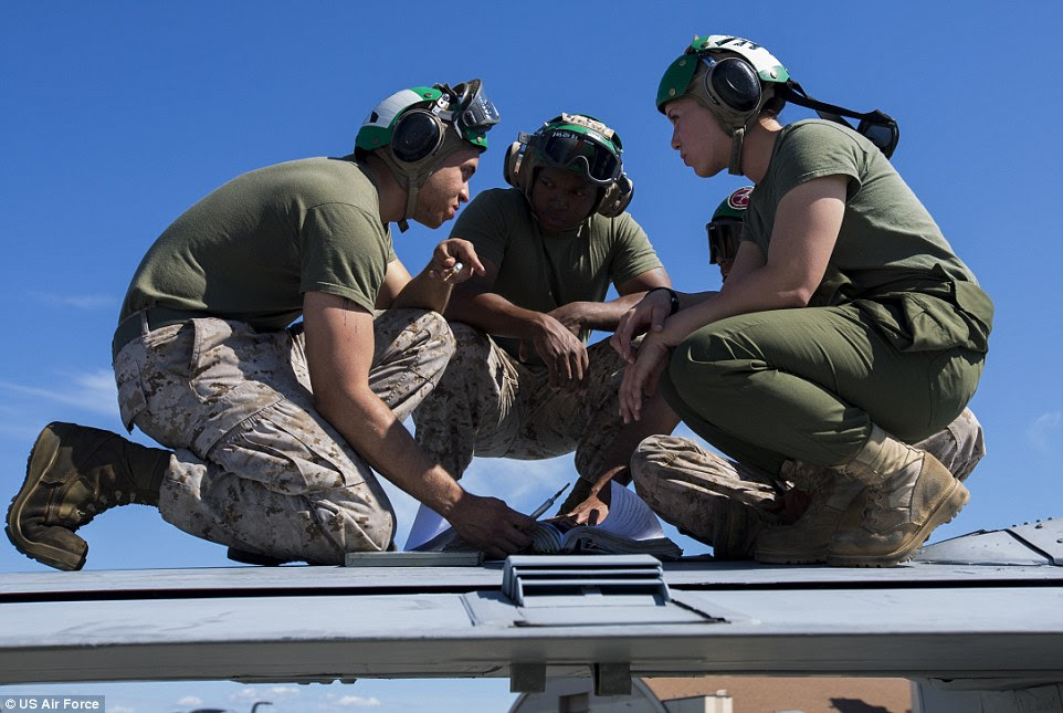 Readiness: U.S. Marines with Marine Tactical Electronic Warfare Squadron (VMAQ) 2,  conduct maintenance on the wing of a U.S. Marine Corps EA-6B Prowler at Eielson Air Force Base. Warmer weather than expected didn't deter the Marines