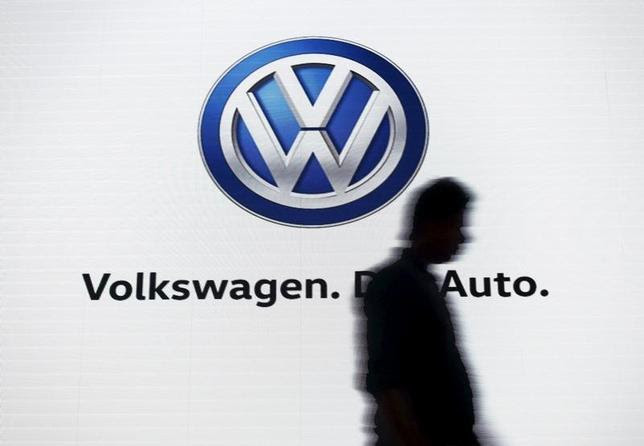 A man walks past a screen displaying a logo of Volkswagen at an event in New Delhi, India, June 23, 2015. REUTERS/Anindito Mukherjee