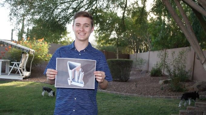 Teen group winner Kyle Corrette holds a (2D) printout of his design.
