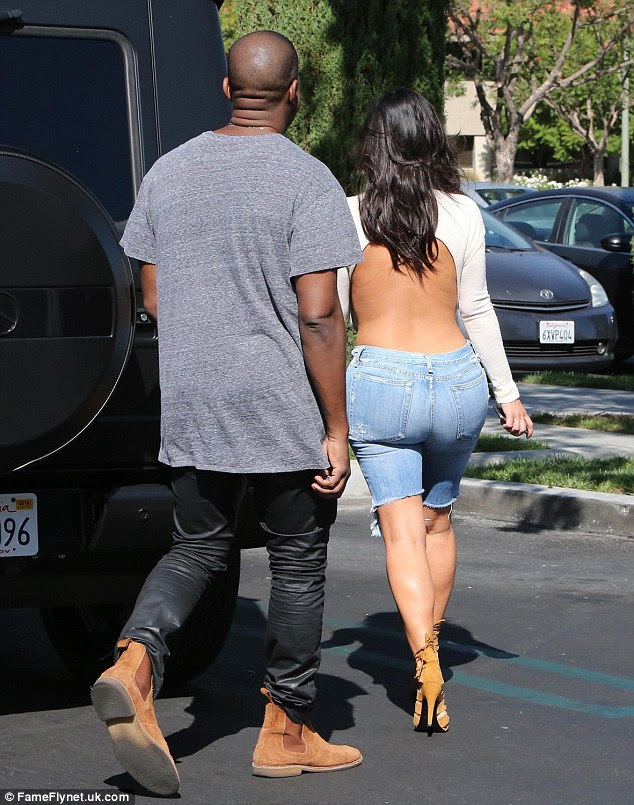 Bold: The 33-year-old reality star showed off almost her entire back in a white sweater with a giant cut-out in the back