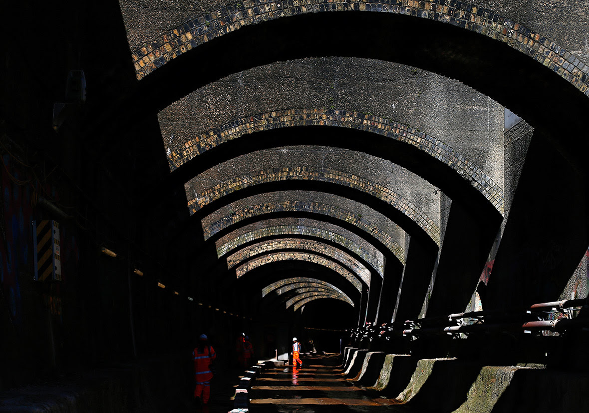 A worker walks out of the Connaught Tunnels section of the Crossrail construction project in East London. Crossrail are nearing completion of the deepening of a disused Victorian era railway tunnel to allow modern electric trains to travel through them. Europe's largest civil engineering project is due for completion in 2018