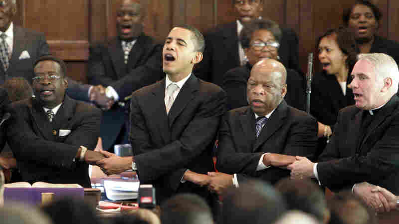 Then-Senator Barack Obama, Rep. John Lewis, D-Georgia, and Rev. Clete Kiley hold hands and sing at the end of a church service in Selma, Ala., on the 2007 commemoration of "Bloody Sunday."