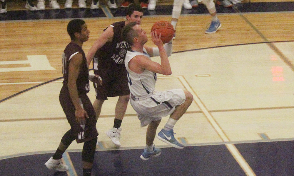 Franklin’s Tim Prunier goes airborne after splitting two defenders in the first half. (Ryan Lanigan/HockomockSports.com)