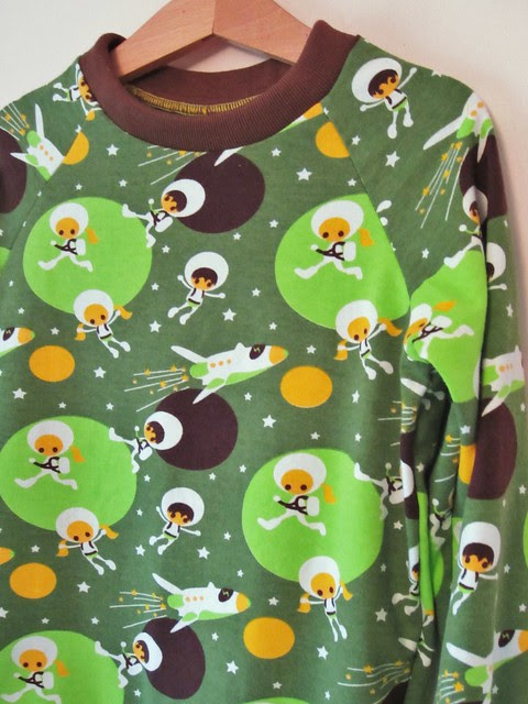 green astronaut top detail