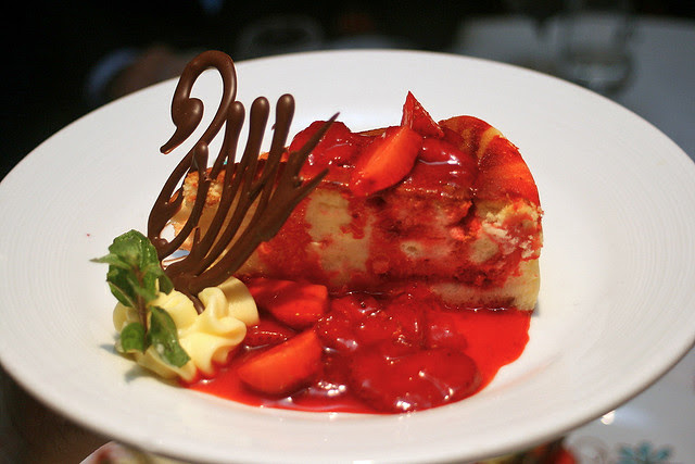 Double strawberry cheesecake - creamy cheesecake laced with strawberry swirl. Served with whipped cream, strawberry compote and a chocolate swan!